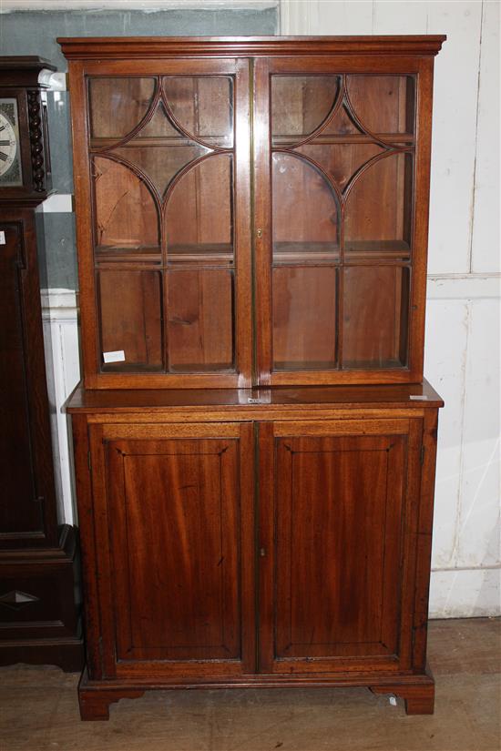 Small Regency mahogany bookcase / cupboard, fitted glazed doors over panelled doors (one pane broken)(-)
